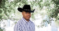 a young man wearing a cowboy hat